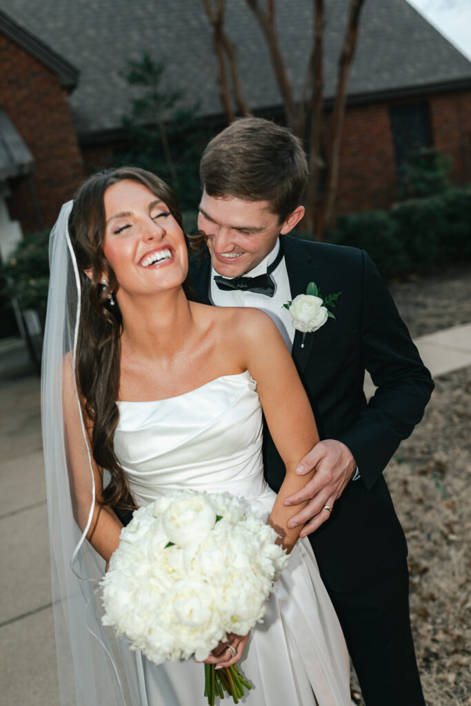 Bride and groom giggling during candid wedding couple portraits