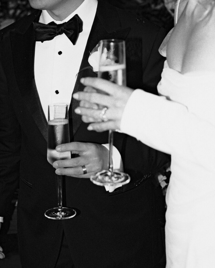bride and groom wedding couple holding champagne film detail photo