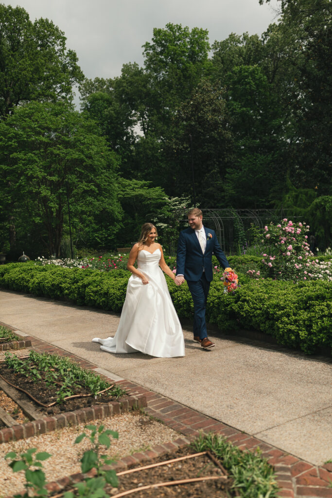 candid wedding photography of couple walking through garden in tennessee