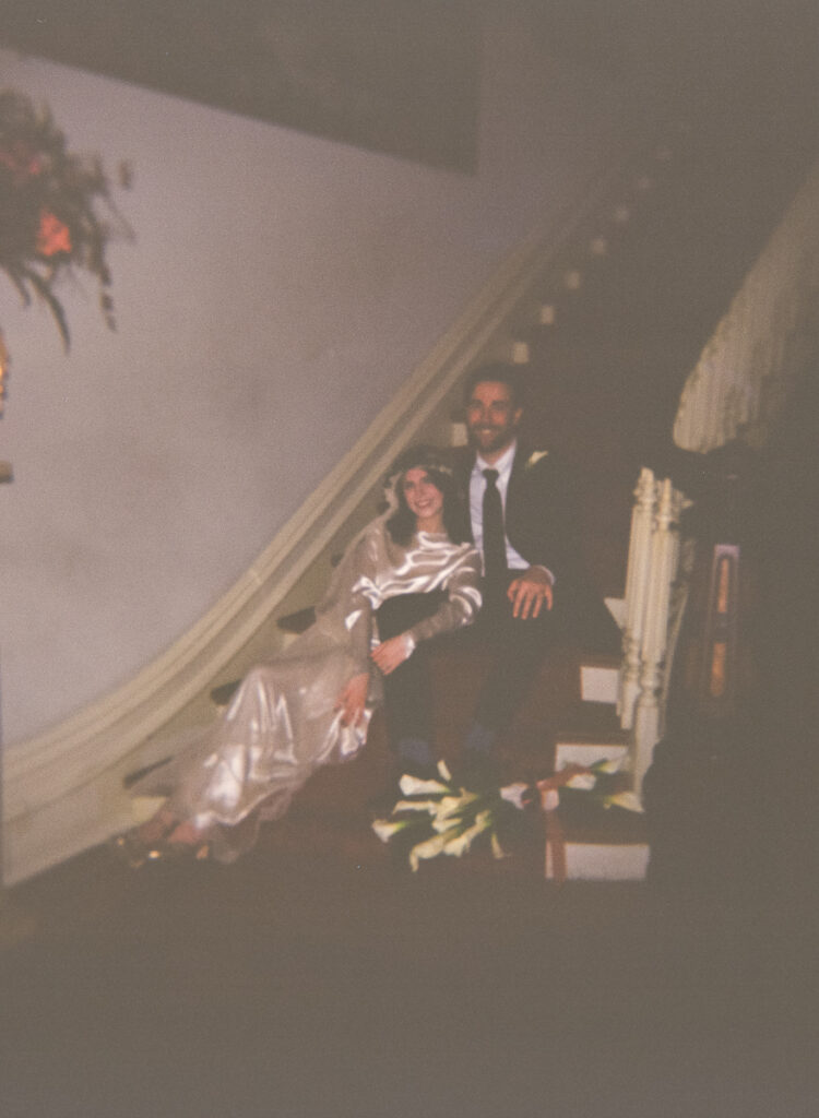 film photo of bride and groom posing on staircase at the fontaine house in memphis, tn